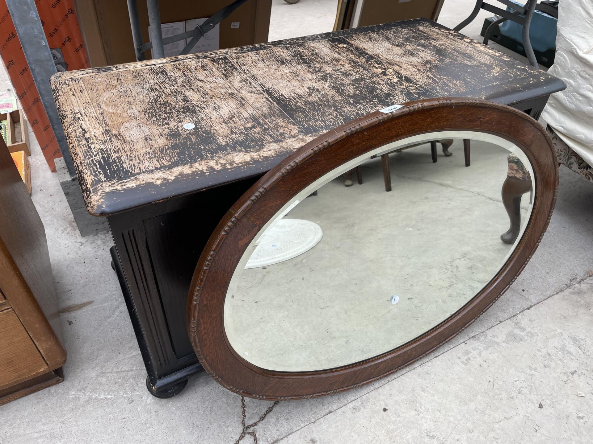 AN OVAL OAK WALL MIRROR AND BLANKET CHEST