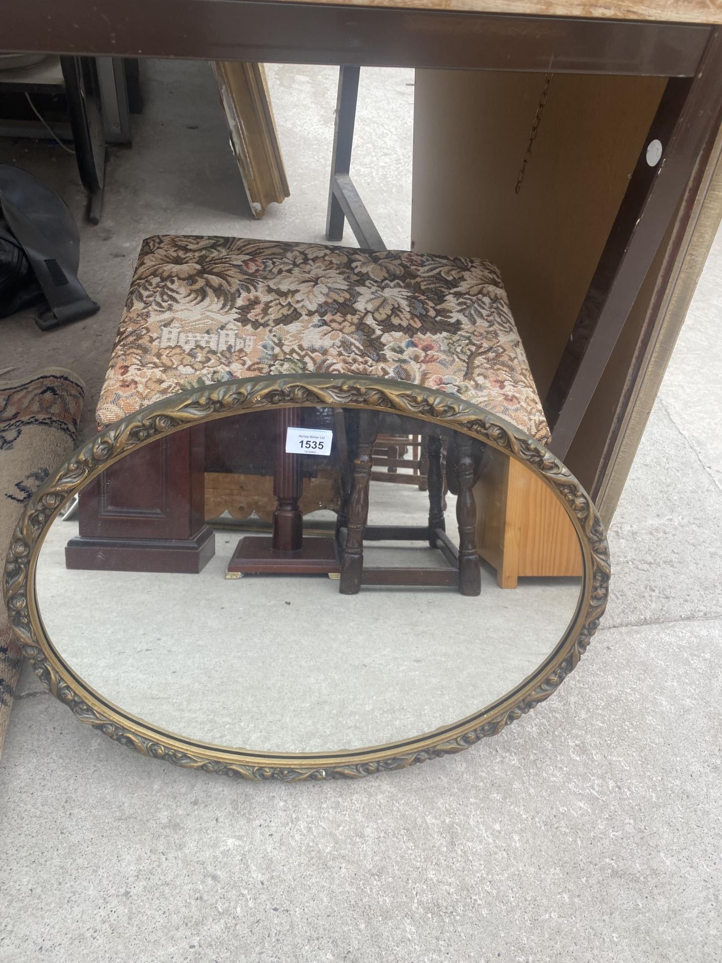 A DECORATIVE FRAMED MIRROR AND AN UPHOLSTERED LIDDED STOOL