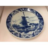 A LARGE BLUE AND WHITE WALL CHARGER PLATE - WITH WINDMILL DESIGN