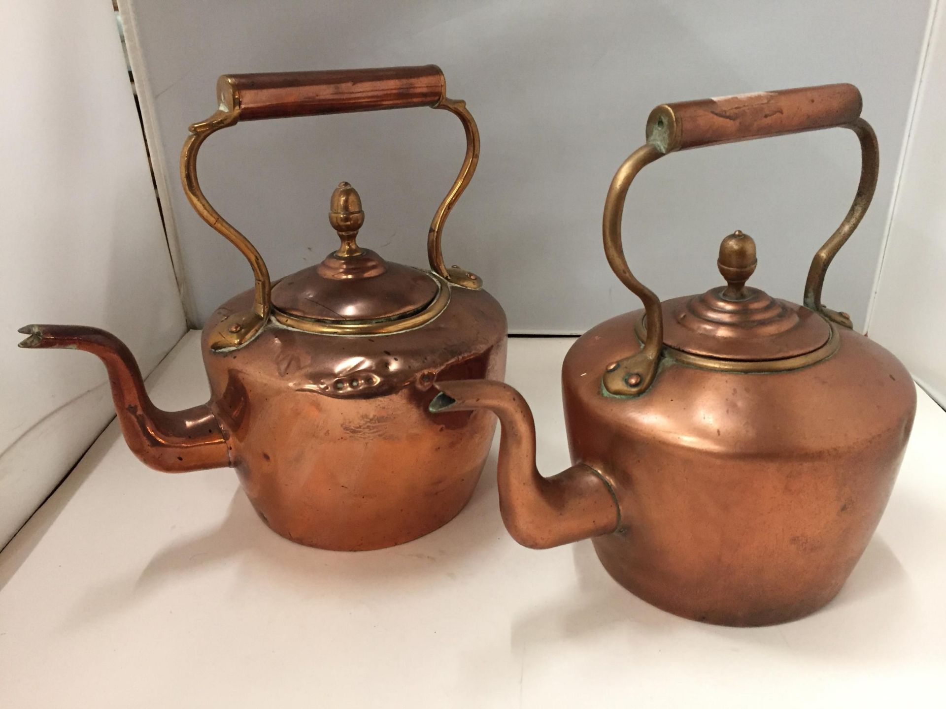 TWO COPPER KETTLES WITH ACORN TOPS