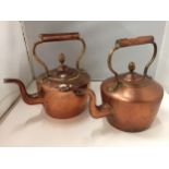 TWO COPPER KETTLES WITH ACORN TOPS