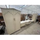 A RANGE OF CREAM AND GILT BEDROOM FURNITURE VIZ. TWO WARDROBES, CHEST OF DRAWERS, DRESSING TABLE,