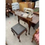 A SINGER ELECTRIC SEWING MACHINE (MODEL 411G) IN WALNUT TABLE ON CABRIOLE LEGS, COMPLETE WITH