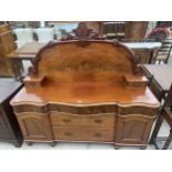 A VICTORIAN MAHOGANY SERPENTINE FRONT SIDEBOARD WITH RAISED BACK, HAVING FOLIATE CARVING, FIVE
