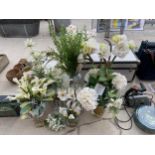 AN ASSORTMENT OF GLASS VASES CONTAINING ARTIFICIAL FLOWERS ETC