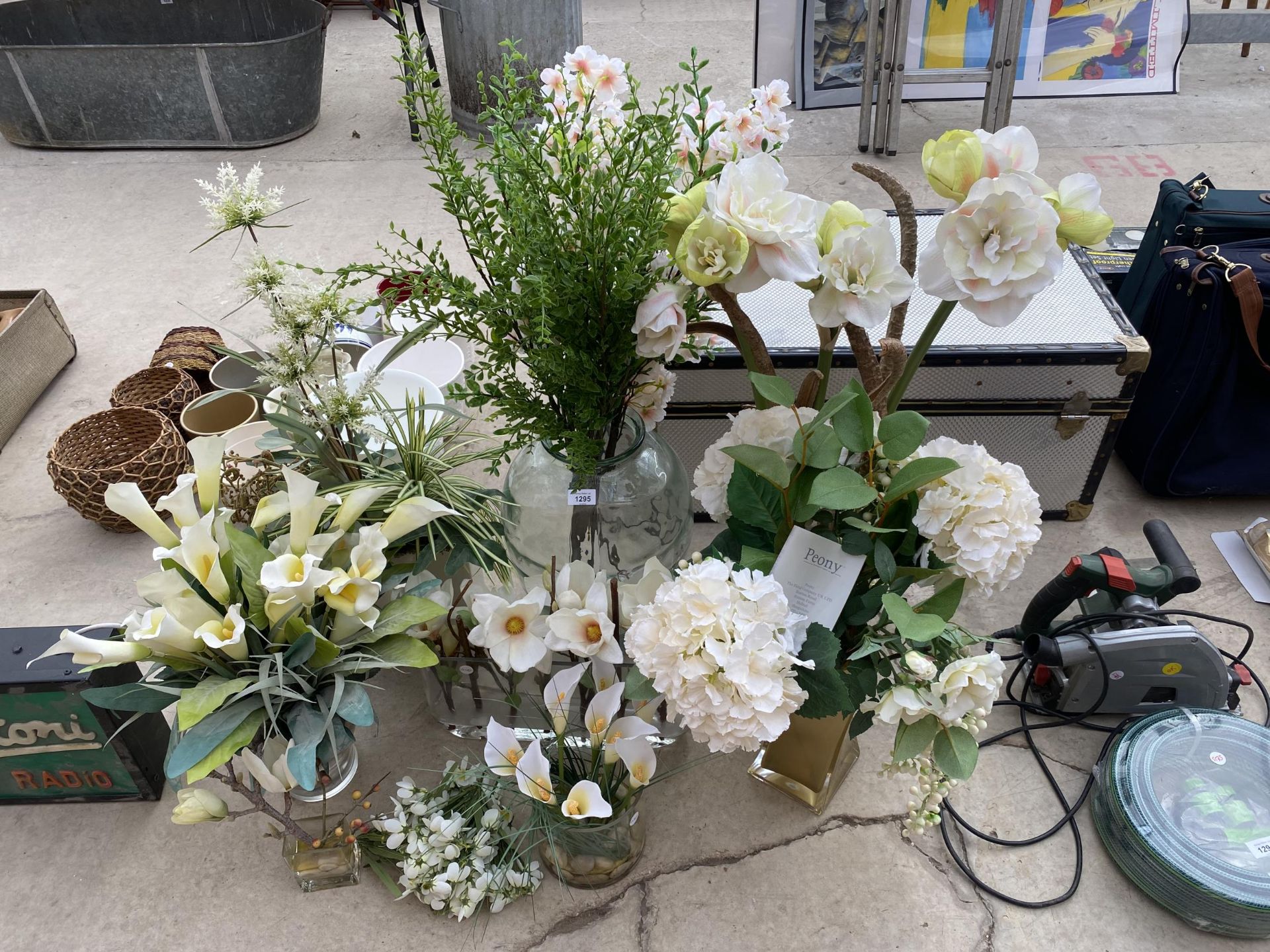 AN ASSORTMENT OF GLASS VASES CONTAINING ARTIFICIAL FLOWERS ETC