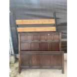 A VINTAGE BED WITH AN OAK HEAD BOARD AND FOOT BOARD