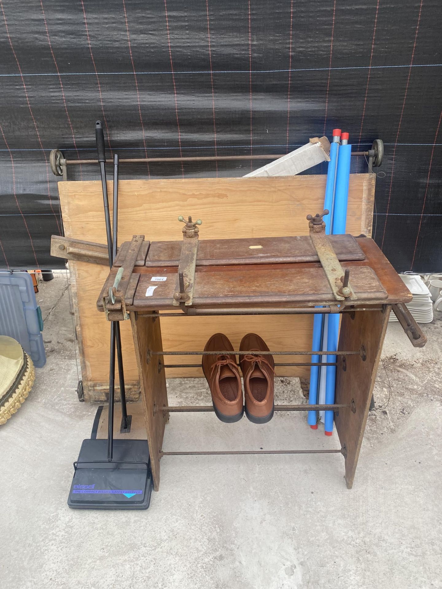 A SHOE RACK WITH A PRESS AND AN ARCHITECTS DRAWING BOARD