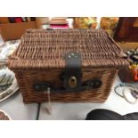 A WICKER PICNIC BASKET WITH PLATES, BOWLS AND CUPS