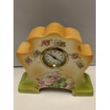 A DECORATIVE CERAMIC MANTLE CLOCK WITH A DELICATE ROSE DESIGN