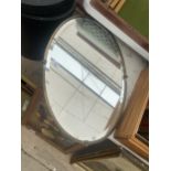 A DECORATIVE BRASS FRAMED BEVELED EDGE MIRROR