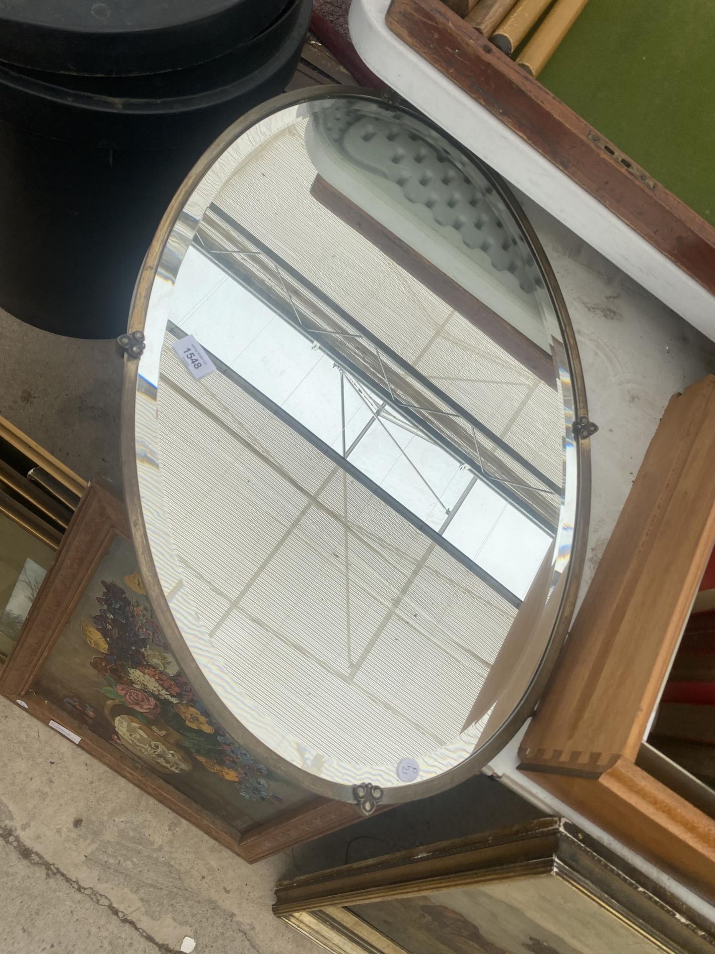 A DECORATIVE BRASS FRAMED BEVELED EDGE MIRROR