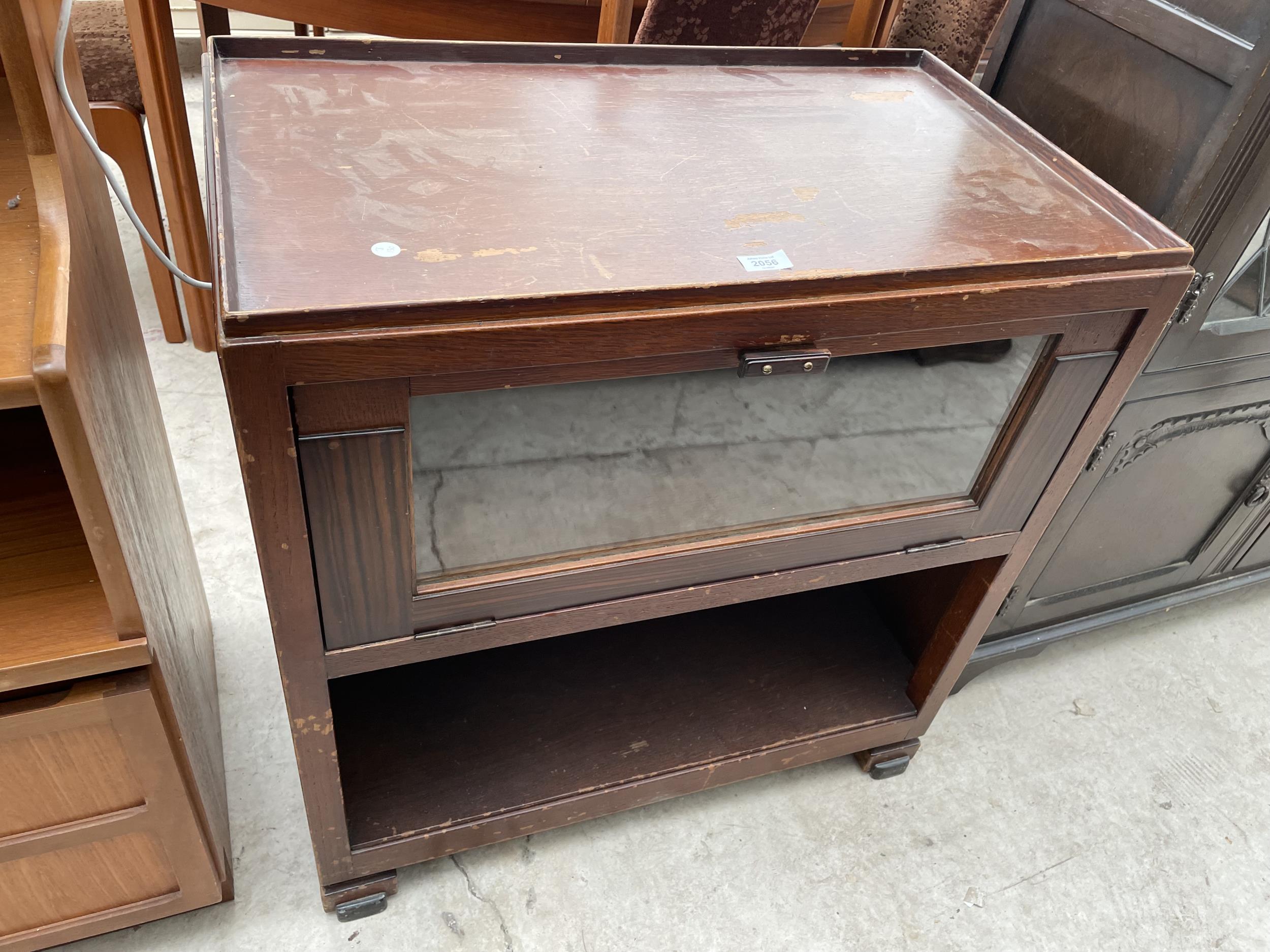 A MID 20TH CENTURY OAK CABINET WITH DROP-DOWN GLASS DOOR ON OPEN BASE, 30" WIDE