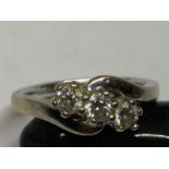 AN 18 CARAT WHITE GOLD RING ON A TWIST WITH THREE IN LINE DIAMONDS SIZE M