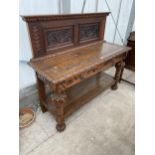 A HEAVILY CARVED VICTORIAN OAK BUFFET WITH TWO DRAWERS, HAVING LION MASK HANDLES AND RAISED BACK,