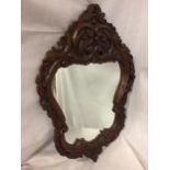 A TREEN SHIELD SHAPED MIRROR