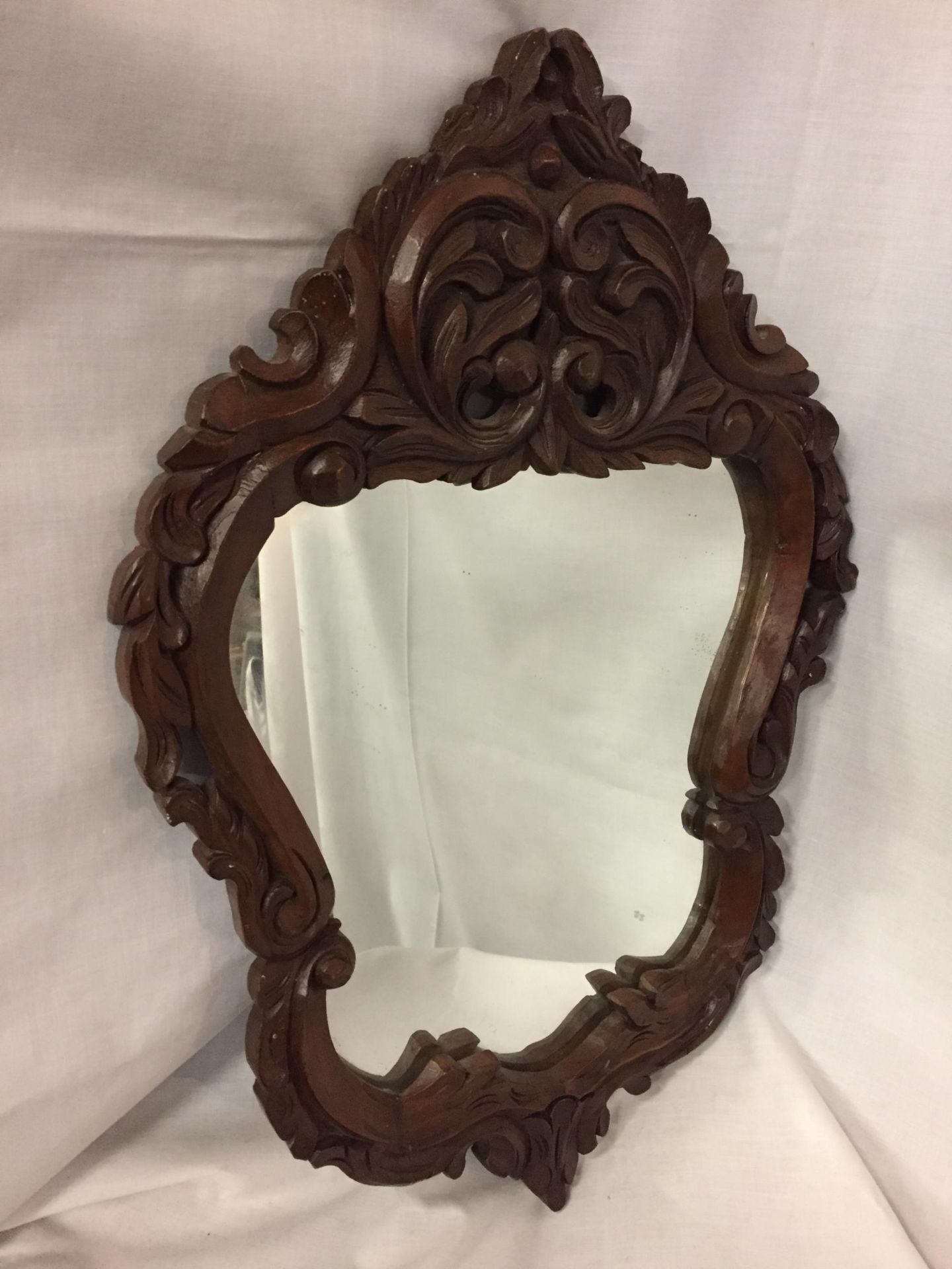 A TREEN SHIELD SHAPED MIRROR