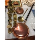 A COPPER WARMING PAN, A BRASS OIL LAMP AND SEVEN BRASS CANDLESTICKS