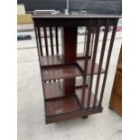 AN EDWARDIAN MAHOGANY AND INLAID REVOLVING BOOKCASE, 18" SQUARE