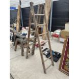 A VINTAGE THREE SECTION WOODEN EXTENDING LADDER (7 RUNGS PER SECTION)