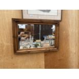 A WOODEN FRAMED MIRROR WITH TRACTOR ETCHING