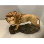 A BESWICK LION ON A ROCK