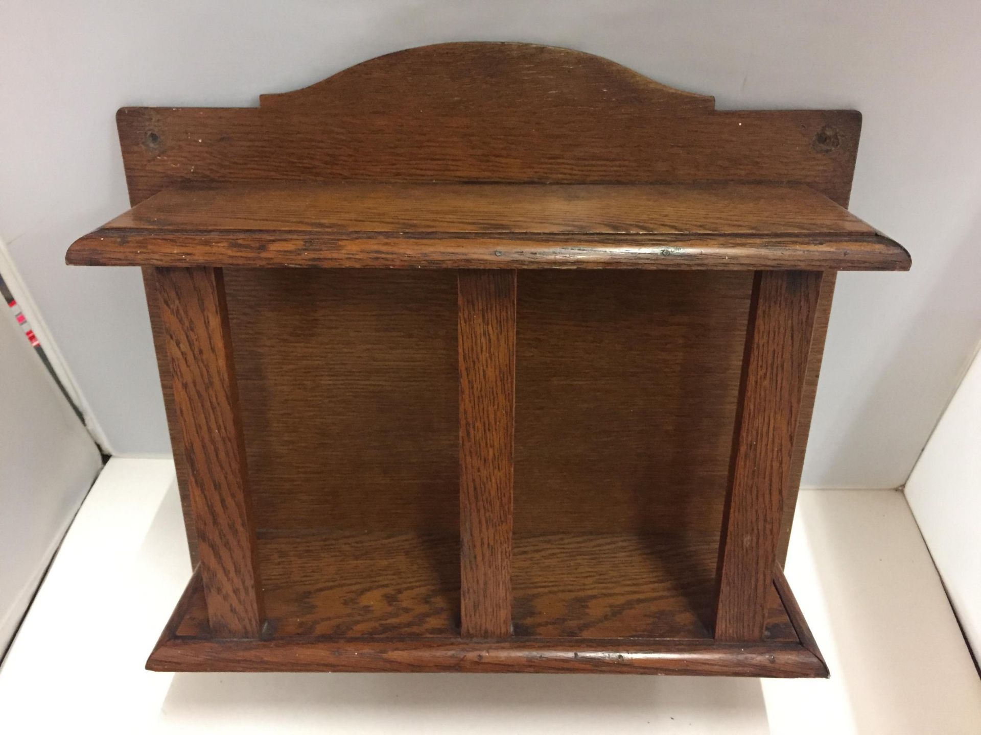 AN UNUSUAL OAK WALL SHELF