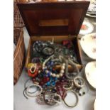 A LARGE COLLECTION OF COSTUME JEWELLERY IN A WOODEN BOX