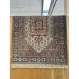 A LARGE PATTERNED KESHAN SUPER RUG