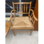 AN ANTIQUE STYLE RUSH SEATED ELBOW CHAIR