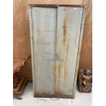 A VINTAGE METAL TWO DOOR STORAGE CUPBOARD