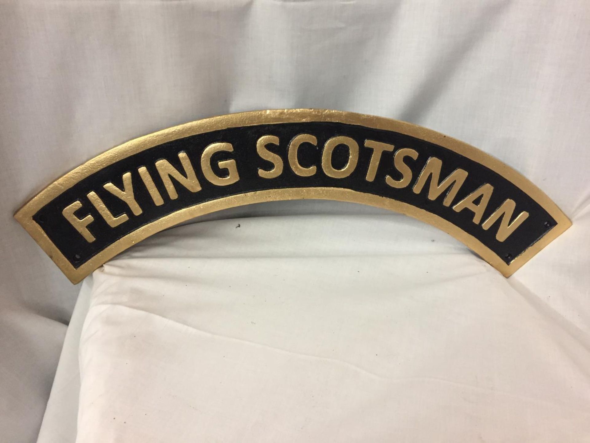 A CAST IRON FLYING SCOTSMAN SIGN