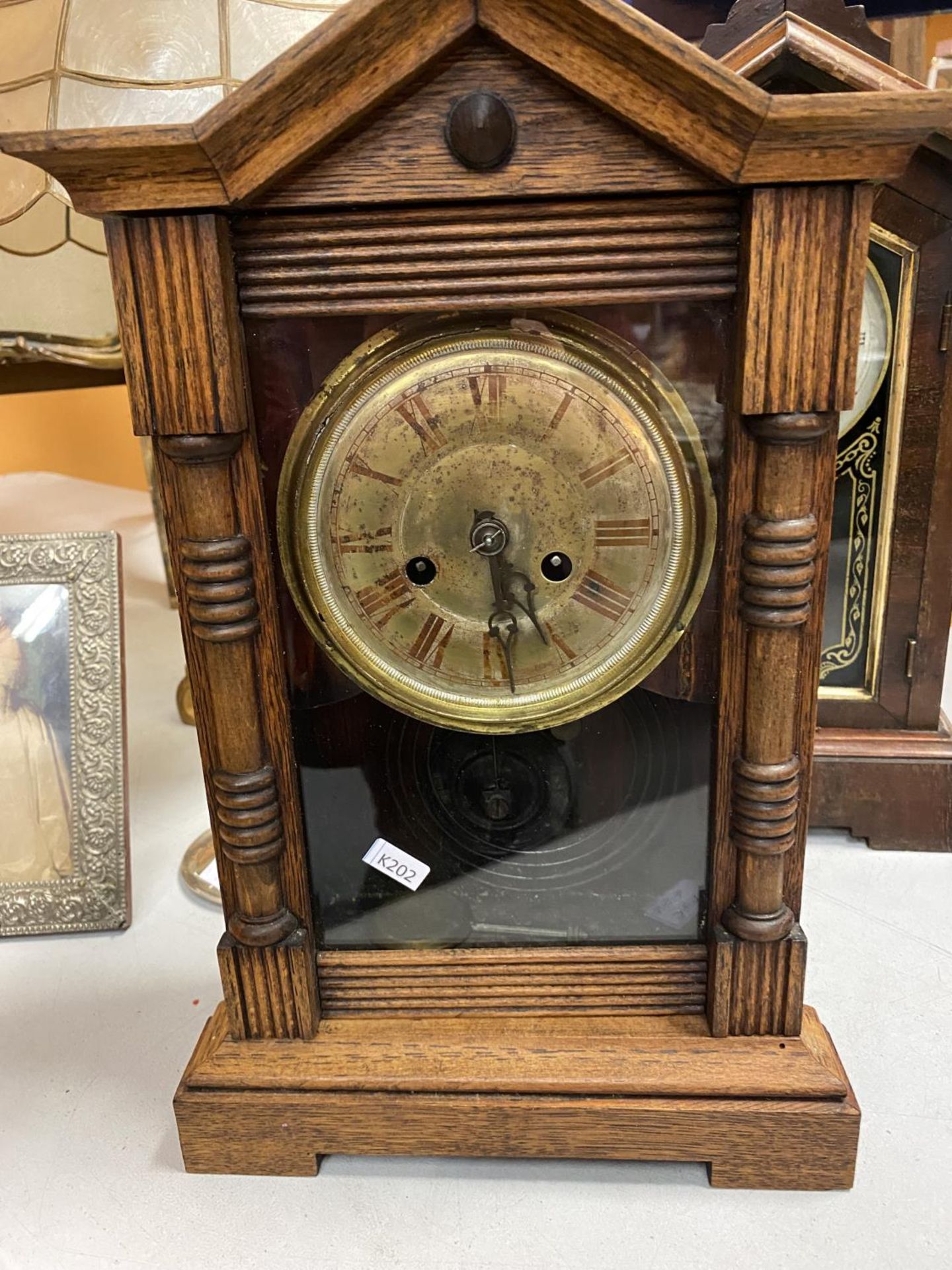 A VINTAGE AMERICAN WOODEN CASE CLOCK WITH A FRONT OPENING FACE