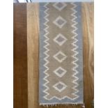 A TRIBAL KALIM FRINGED CARPET RUNNER