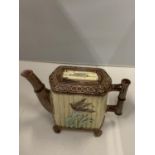 A VICTORIAN MAJOLICA TEAPOT WITH A BAMBOO STYLE HANDLE AND SPOUT DECORATED TO THE SIDE WITH A