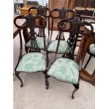 A SET OF FOUR LATE VICTORIAN PARLOUR CHAIRS ON FRONT CABRIOLE LEGS, WITH PIERCED SPLAT BACKS AND