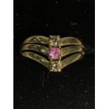 A 9 CARAT GOLD RING IN A WISHBONE DESIGN WITH THREE STONES SIZE L/M GROSS WEIGHT 2.4 GRAMS