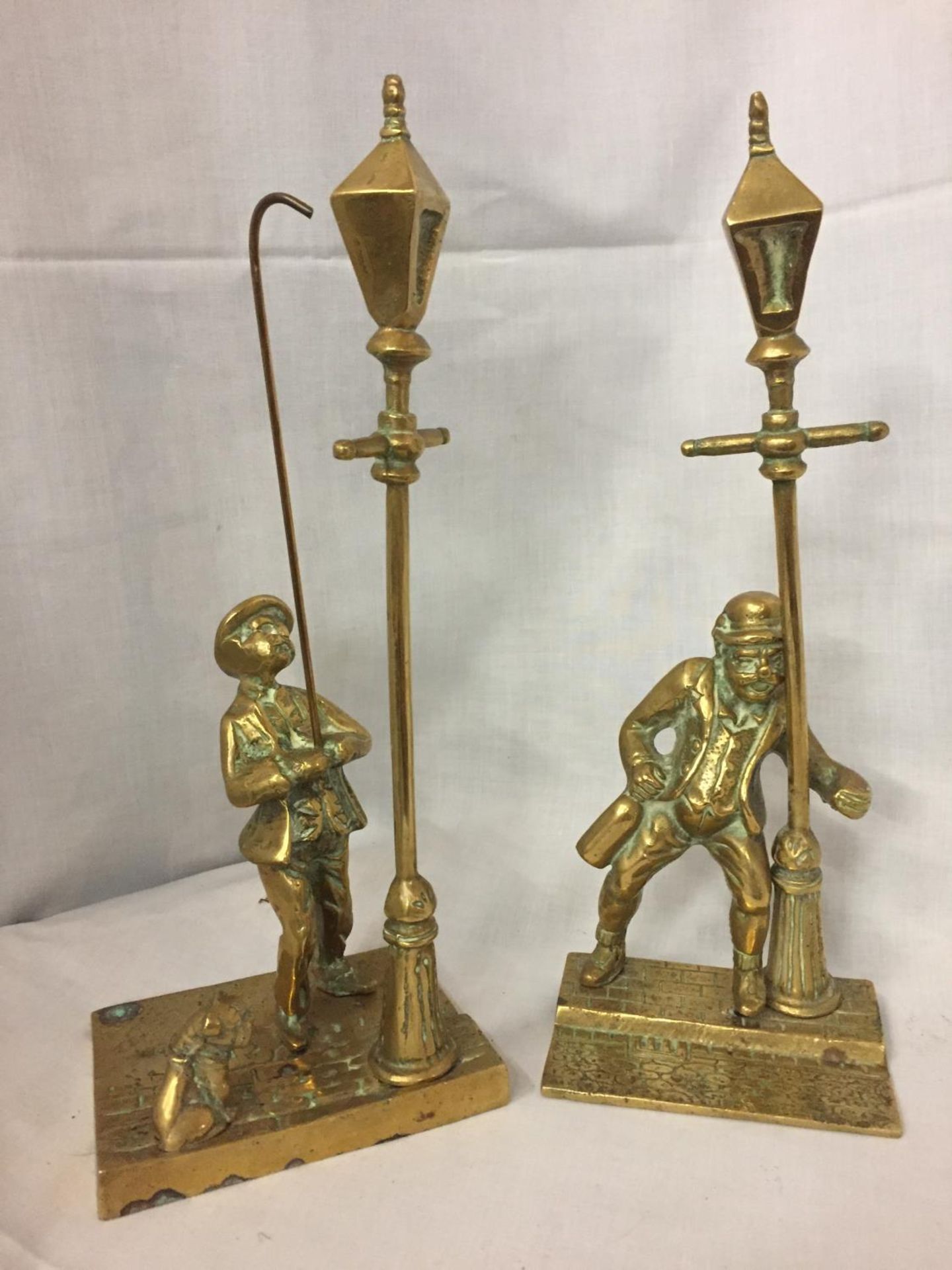 TWO BRASS FIGURES, ONE OF A STREETLAMP LIGHTER WITH DOG AND ONE OF A DRUNKEN MAN