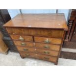 A GEORGE III OAK AND MAHOGANY CROSSBANDED CHEST OF TWO SHORT AND THREE LONG DRAWERS WITH SECRET