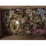 A BOX OF YELLOW METAL COSTUME JEWELLERY