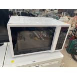 A WHITE DAEWOO MICROWAVE OVEN