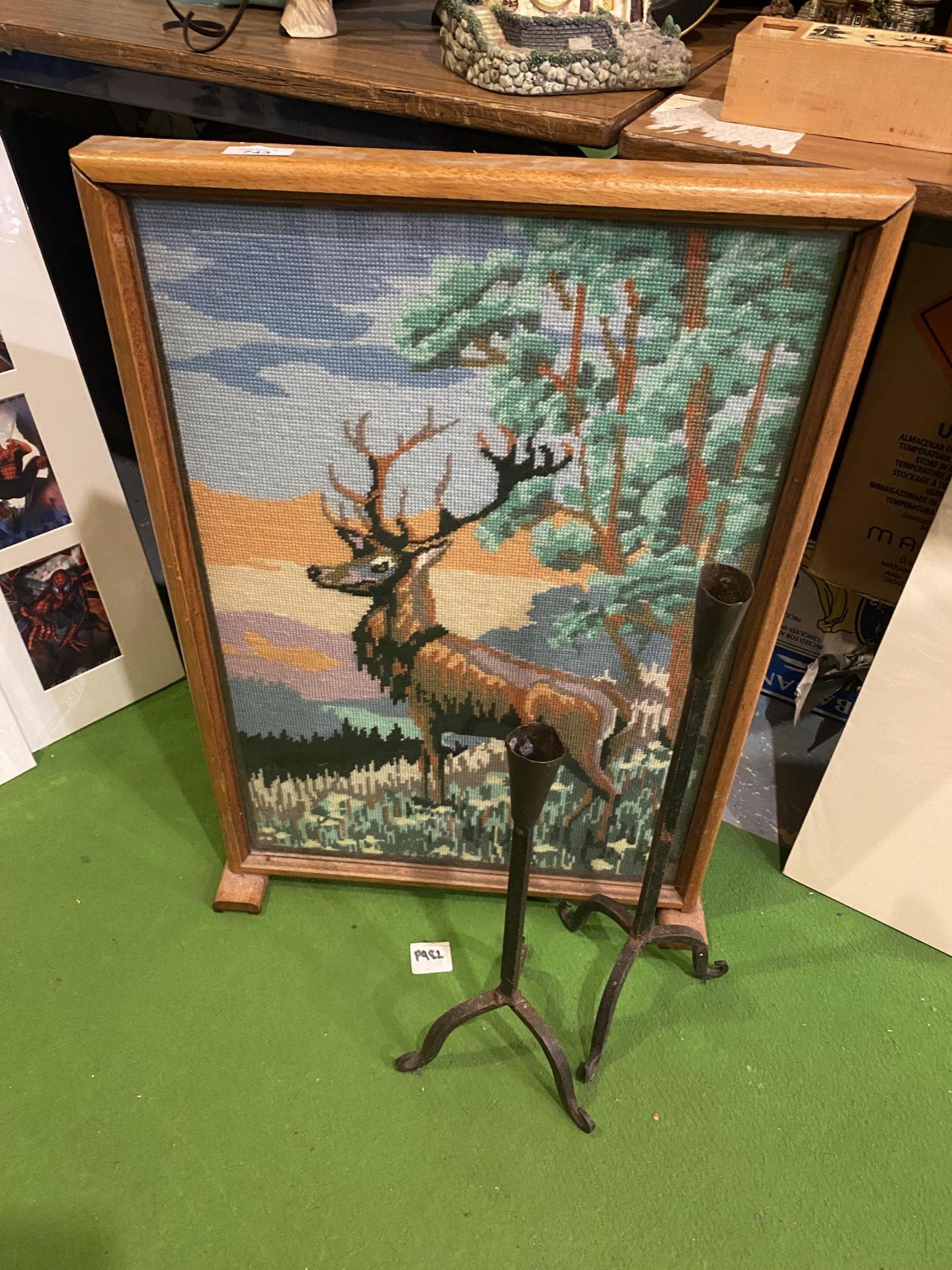 A FIRE SCREEN WITH A TAPESTRY OF A STAG AND TWO RUSTIC IRON CANDLE HOLDERS