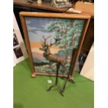 A FIRE SCREEN WITH A TAPESTRY OF A STAG AND TWO RUSTIC IRON CANDLE HOLDERS