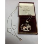 A SILVER NECKLACE WITH A LION PENDANT IN A PRESENTATION BOX