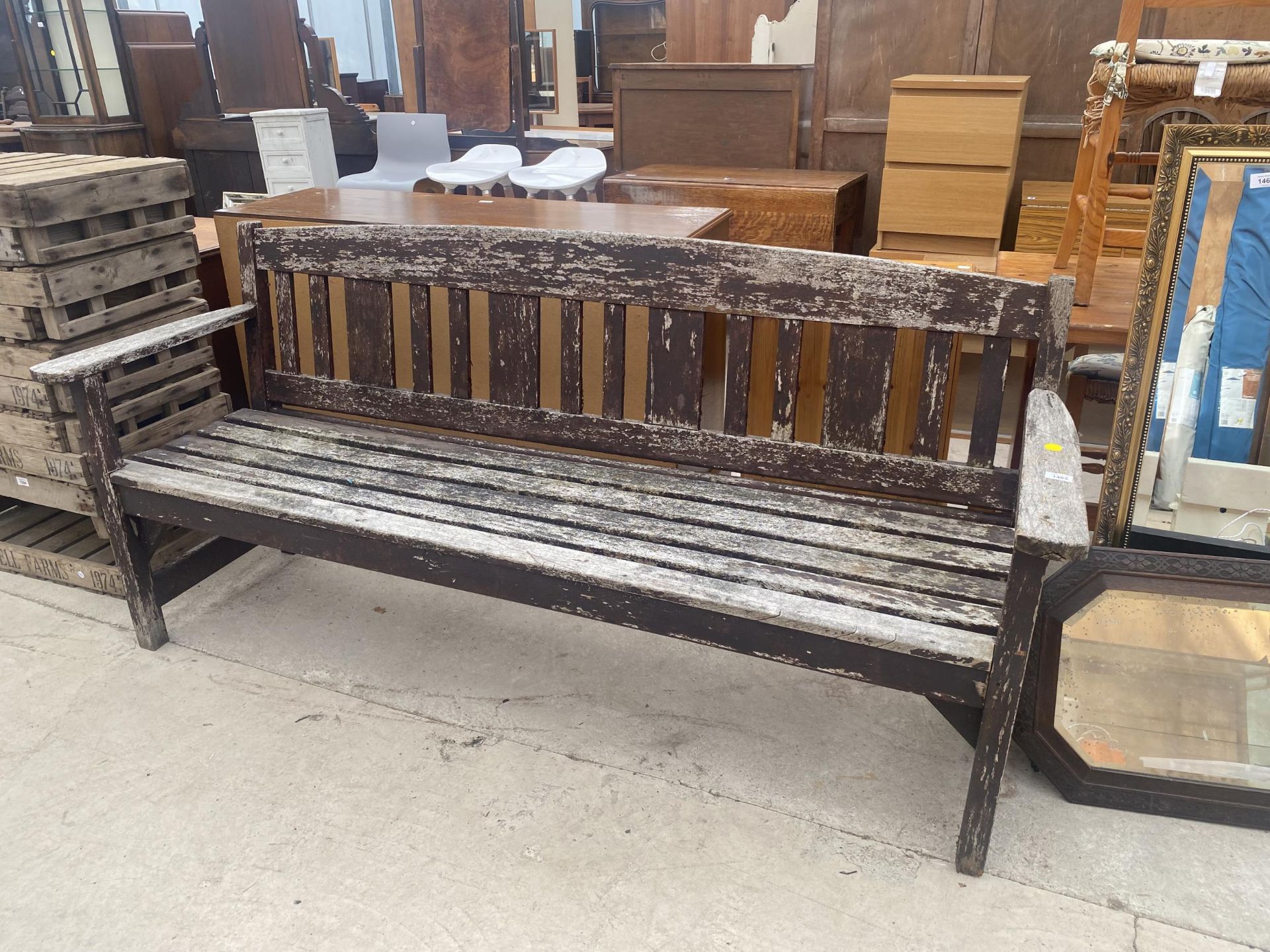 A LARGE WOODEN SLATTED GARDEN BENCH