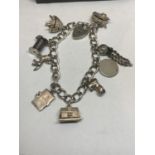 A SILVER CHARM BRACELET WITH NINE CHARMS TO INCLUDE AN OPENING BEE HIVE WITH BEE, COTTON REEL,