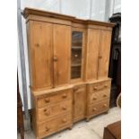 A VICTORIAN PINE INVERTED BREAKFRONT HOUSEKEEPERS CUPBOARD WITH SIX DRAWERS AND CUPBOARD TO THE