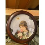 A PLATE OF A YOUNG GIRL IN A CIRCULAR FRAME