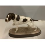 A BESWICK POINTER ON A CERAMIC PLINTH