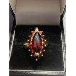 A 9 CARAT GOLD RING MARKED 375 WITH A LARGE RED STONE SIZE P GROSS WEIGHT 3.7 GRAMS